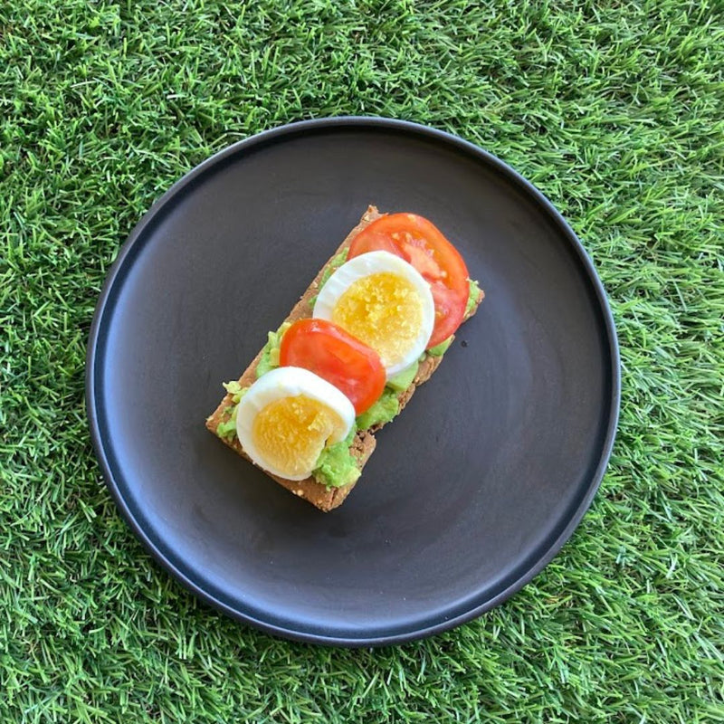 Fello Protein Bar topped with avocado, hard boiled eggs, tomatoes.