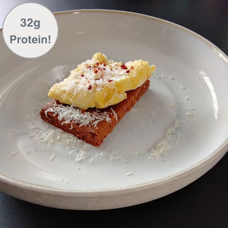 Fello Protein Bar topped with eggs, parmesan, red pepper flakes. 32g of protein per serving.