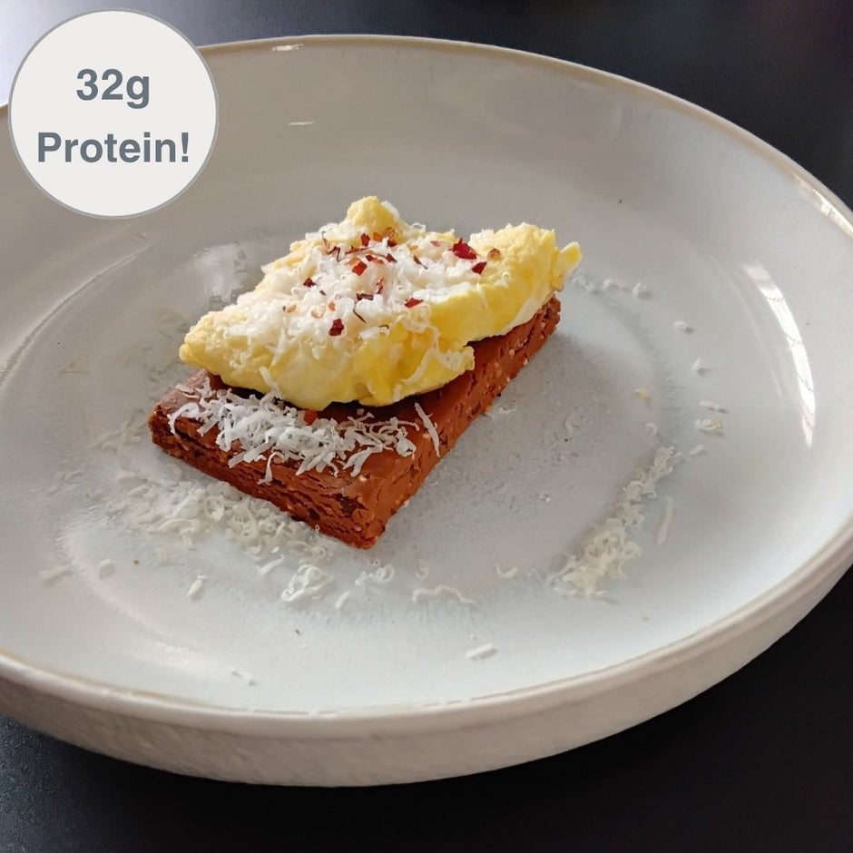 Fello Protein Bar topped with eggs, parmesan, red pepper flakes. 32g of protein per serving.