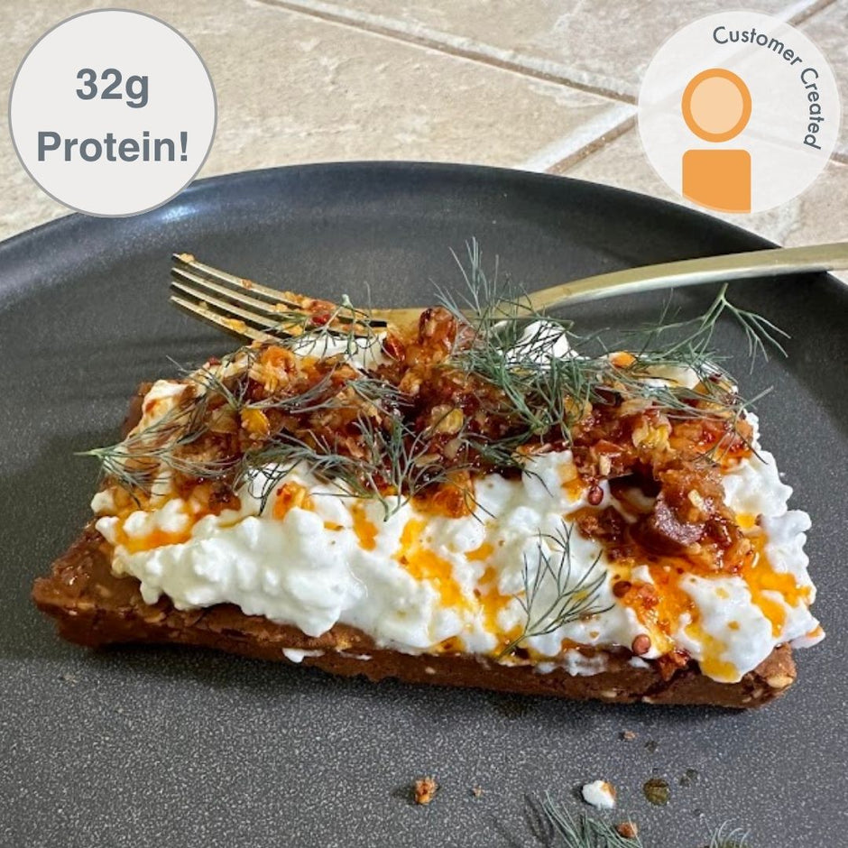 Fello Spicy Pizza Bar topped with cottage cheese, chili crunch, and herbs.  32g of protein per serving.  Fan Recipe.