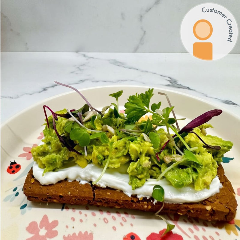 Spicy Pizza Protein bar topped with labneh, avocado, and microgreens.