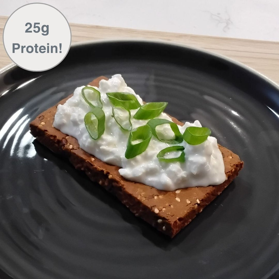Fello Spicy Pizza protein bar topped with cottage cheese and green onion. 25g of protein per serving.